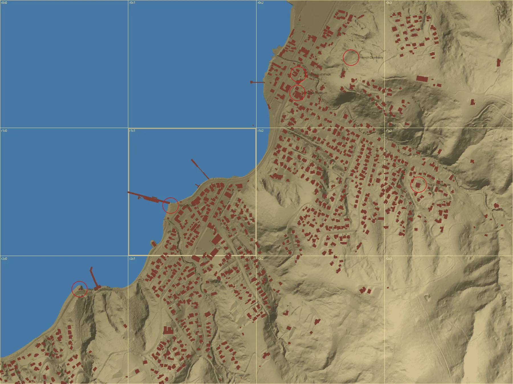 Relief map of Akaroa town centre from above, buildings in red, with points marked for the main wharf, Rue Lavaud shops, the museum and the lighthouse.